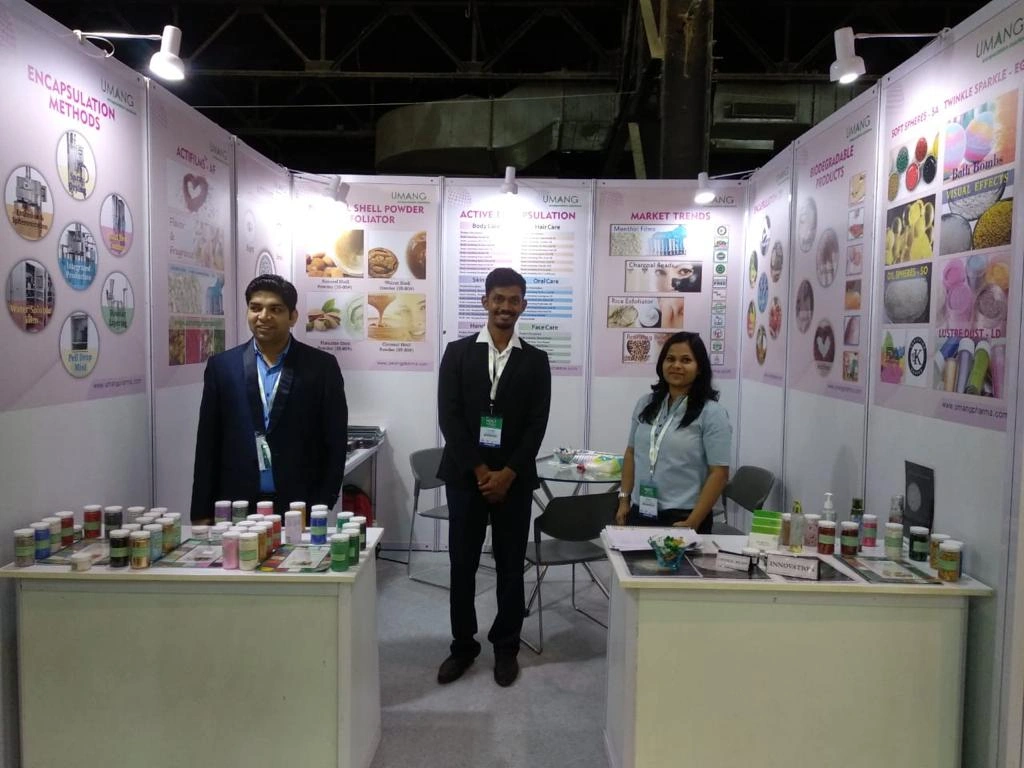 Visitors engaging with UMANG GLOBAL GROUP representatives at the HPCI cosmetic ingredients exhibition